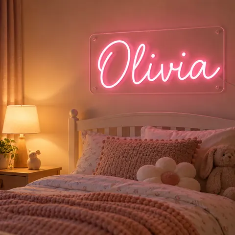 Child’s bedroom with a soft pink “Olivia” neon name sign on the wall above a white bed