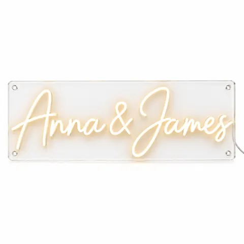 Wedding neon sign example: “Anna & James” in warm white LED neon script on a clear acrylic board, lit, on a white background