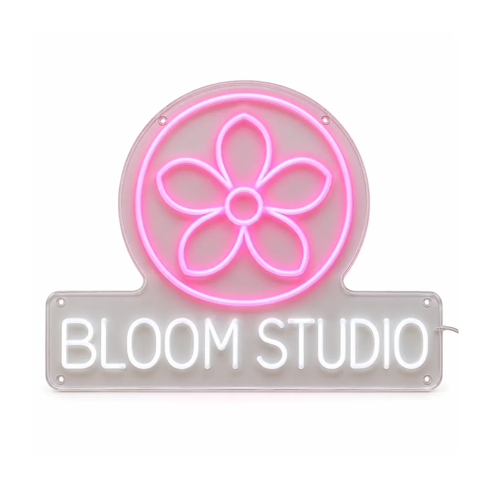 Logo neon sign example: a pink flower in a circle above “BLOOM STUDIO” in white neon capitals on clear acrylic, on a white background